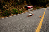 A downhill skateboarder rides down a steep mountain Malibu, California, United States of America