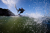 A skilled male surfer launches an air Malibu, California, United States of America