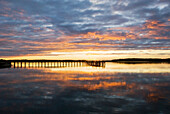 A silhouette of a pier at sunset on the Intracoastal Waterway on Hilton Head Island, SC Hilton Head Island, South Carolina, USA