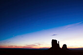 The famous Mittens are silhouetted at sunrise in Monument Valley, Arizona, Monument Valley, Arizona, USA