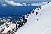 A skier descends from the summit of Mount Shasta, California Mount Shasta, California, USA