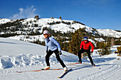 A man and woman cross country ski at Kirkwood Mountain Resort, California Kirkwood, California, USA