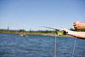 A short focus view of a fly fishing cast with the Snake River in the background Jackson Hole, Wyoming, U.S.A.
