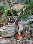 A woman doing yoga postures in outdoor setting Birmingham, Alabama, USA