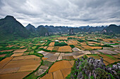 Patchwork farms stretch between the Karst mountains of Yanghsuo County, China Fuli Village, Yangshuo County, Guangxi, China