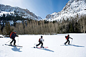 A father and his two sons skinning through the backcountry of California Sierra, CA, USA