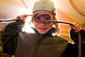 A boy poses for a portrait while playing in Lake Tahoe, California Truckee, CA, USA