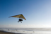A Motorized Hang Glider takes off from the beach over the Pacific Ocean in La Fonda, Baja, Mexico La Fonda, Baja Norte, Mexico