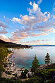 Beautiful clouds are illuminated at sunset over Sand Harbor and Lake Tahoe, Nevada Lake Tahoe, Nevada, USA
