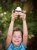 girl poses with cupcake, portland, me, usa