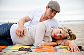 Couple laying on a blanket at the beach Cannon Beach, Oregon, USA