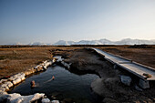 A man enjoys a hot spring near the mountains Bishop, California, United States
