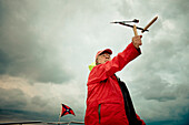 A man on a boat checks the wind USA