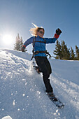 A woman snowshoeing on Molas Pass, San Juan National Forest, Silverton, Colorado (backlit)., Durango, Colorado, usa