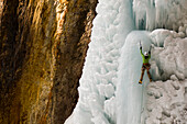A woman ice climbing a frozen waterfall, Silverton, Colorado., Silverton, Colorado, usa