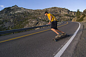 Man skateboarding on road in California Donner Summit, California, United States