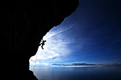 Man climbing against blue sky Lake Tahoe, Nevada, United States