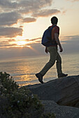 Hiker on cliff trail on rocky ocean coast Sydney, New South Wales, Australia