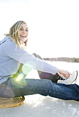 Woman laces up skates Scarborough, Maine, United States