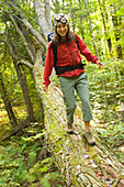 Young woman playing in forest in rural Lake Ossipee, New Hampshire New Hampshire, United States