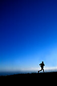 Silhouette of a man running above the ocean Fort Bragg, California, United States