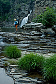Woman standing below Linville Falls with headlamp, Pisgah National Forest, North Carolina Spruce Pine, North Carolina, USA