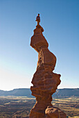 Woman of top of sandstone spire, Fisher Towers, Utah Moab, Utah, USA
