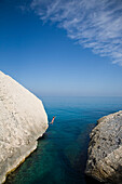 Woman leaps into the ocean, Sardinia, Italy, Sardinia, Italy