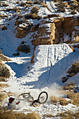Mountain biker crashing in snow, Moab, Utah Moab, Utah, USA