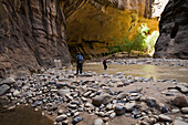Two hikers wade up the Zion Narrows, Zion National Park, Utah Zion National Park, Utah, USA