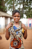 Visitor with snake around her neck, Python temple, Ouidah, Atlantique Department, Benin