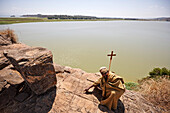 Monk crouching at resting place of Saint Mary, Tana Cherkos monastery island, Lake Tana, Amhara region, Ethiopia
