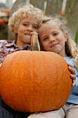 Brother and sister holding pumpkin, Virginia Beach, VA
