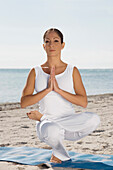 Hispanic woman practicing yoga, Miami, FL