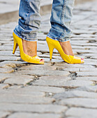 Close up of African woman wearing yellow high heels, Jersey City, NJ