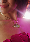 Close up of boom box necklace on Hispanic woman, Jersey City, NJ