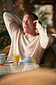 Caucasian man talking on cell phone in restaurant, Virginia Beach, VA