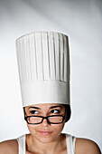 Hispanic woman in chef's hat and eyeglasses, New York, NY