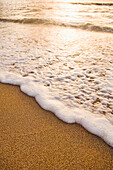 Foamy wave on beach, Island of Kauai, Hawaii, United States
