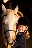 Caucasian girl standing with horse, Manakin, VA, Goochland