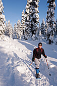 Hispanic woman snowshoeing in remote area, Vancouver, BC, Canada