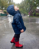 Caucasian boy catching raindrops on tongue, Torrance, California, United States