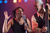 Black woman singing on stage with jazz band, Rockville, Maryland, USA