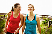 Laughing athletic friends standing together outdoors, San Diego, California, United States