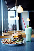 Cheeseburger, french fries and milkshake in diner, Sacramento, California, United States