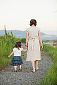 Caucasian mother and daughter walking on path, South Jordan, Utah, United States