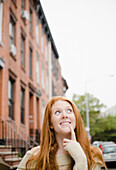 Caucasian woman thinking outdoors, Brooklyn, New York, USA