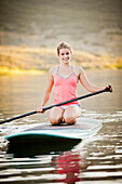 Caucasian woman on stand up paddle board, Heber, Utah, USA