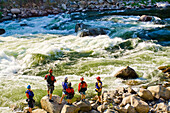 Caucasian family standing near rapids in river, Banks, Idaho, USA