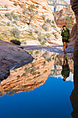 Persian woman standing near pool in canyon, Zion National Park, Utah, USA
